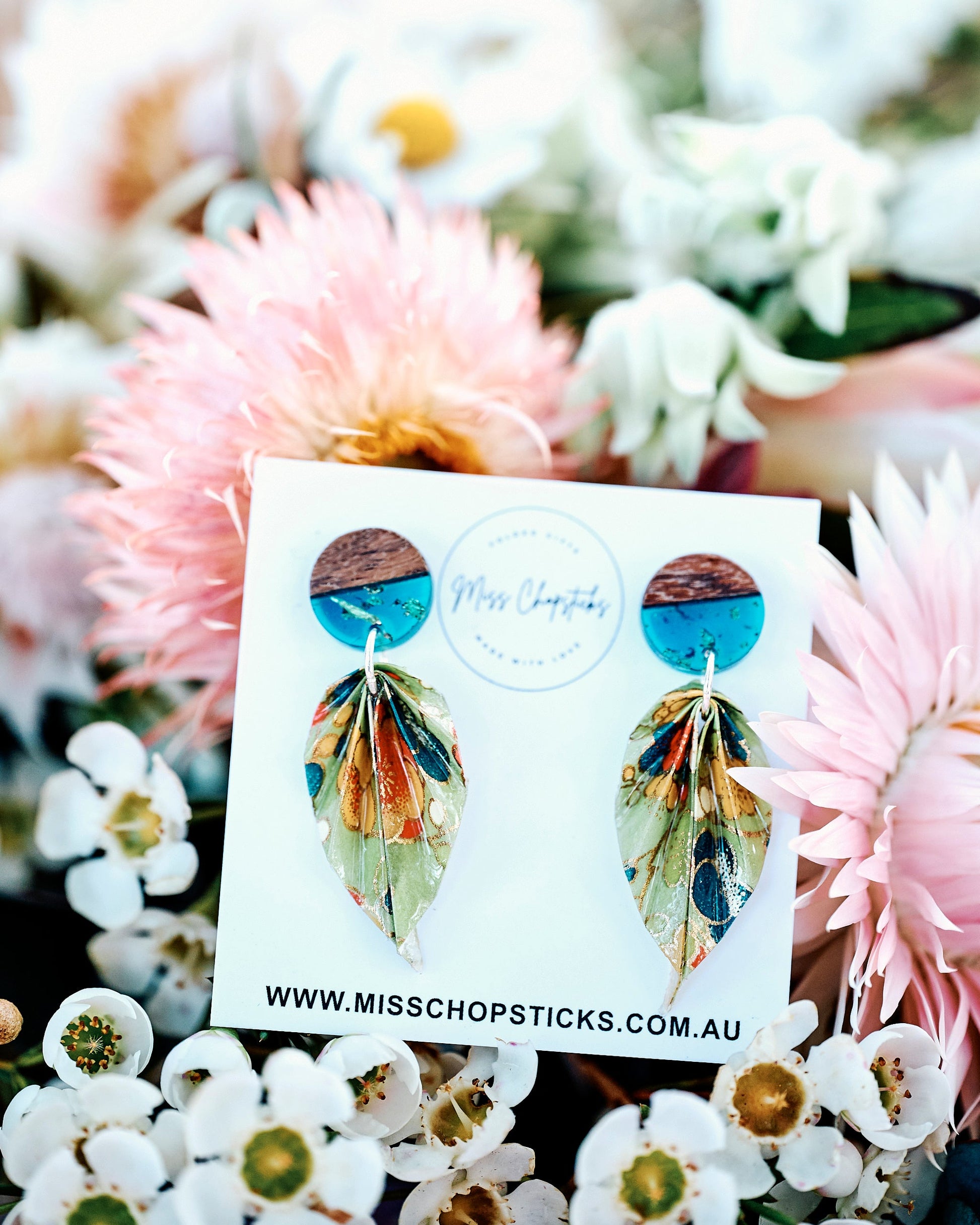 Earrings on a card with floral background